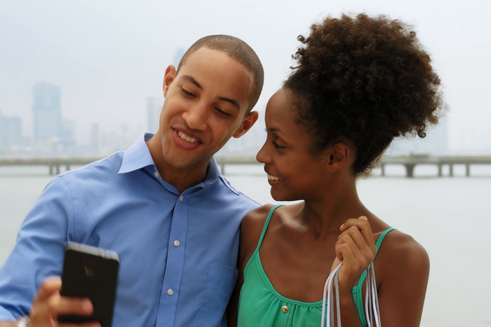 A man and his girlfriend take a selfie [Credit: Videoblocks]