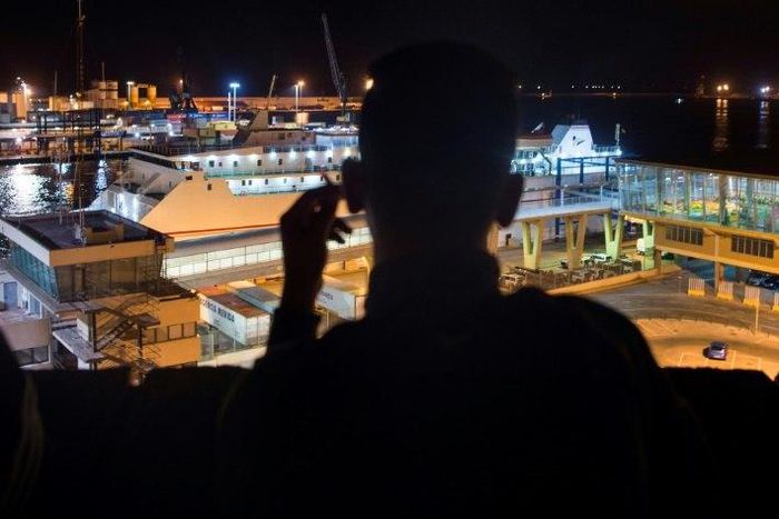 A Moroccan youth looks out over the harbour in the Spanish city of Melilla, on September 20, 2018. Having left their homes, some of these young people try to travel to Europe by jumping on the back of a truck or a bus in the port