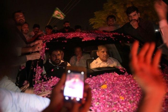 Former Pakistani prime minister Nawaz Sharif was driven away in an SUV as it was pelted with rose petals in celebration, with younger brother Shahbaz Sharif in the front seat of the vehicle