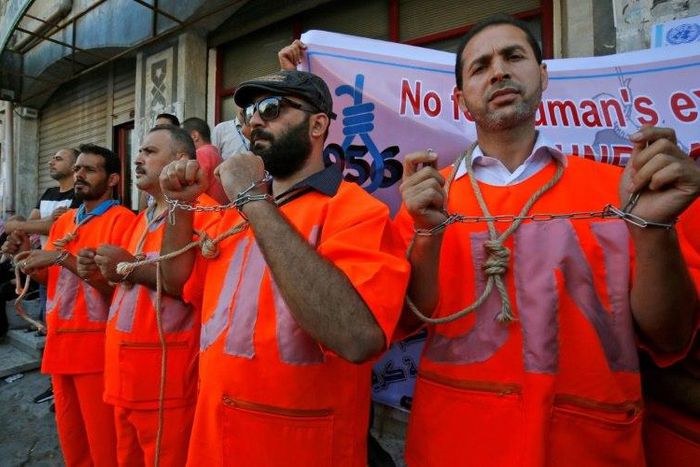 Palestinian employees of UNRWA protest against job cuts at the agency in Gaza City on September 19, 2018