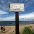 People exit the beach near a "Recent Shark Sighting" sign in 2012 at High Head Beach in Cape Cod, Massachusetts