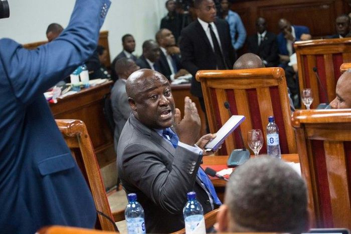 Haitian Senator Evaliere Beauplan debates with his colleagues during the marathon ratification session of Prime Minister Jean Henry Ceant's general government policies