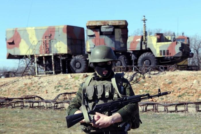 A Russian soldier stands guard in front of an S300 surface-to-air missile battery like those delivered to Syria after a September Israeli strike during which a Russian aircraft was accidentally downed