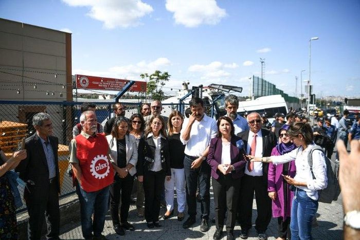 Activists address the media outside Metris prison after a Turkish court kept 24 workers in custody ahead of a trial over their actions in protests against labour conditions at Istanbul's giant new airport