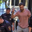 Pussy Riot punk group activist Pyotr Verzilov (C) with police outside a courthouse in Moscow earlier this year