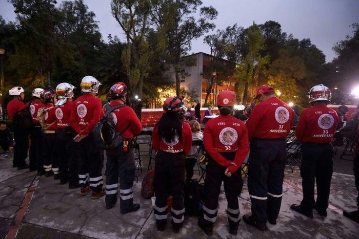Members of the "Los Topos" (The Moles) rescue team pay homage to the victims of the devastating 1985 earthquake, in Tlatelolco neighbourhood in Mexico City, on September 19, 2018