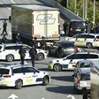 Police block a road to the Oresund Bridge which connects Denmark and Sweden on Friday as part of a massive manhunt