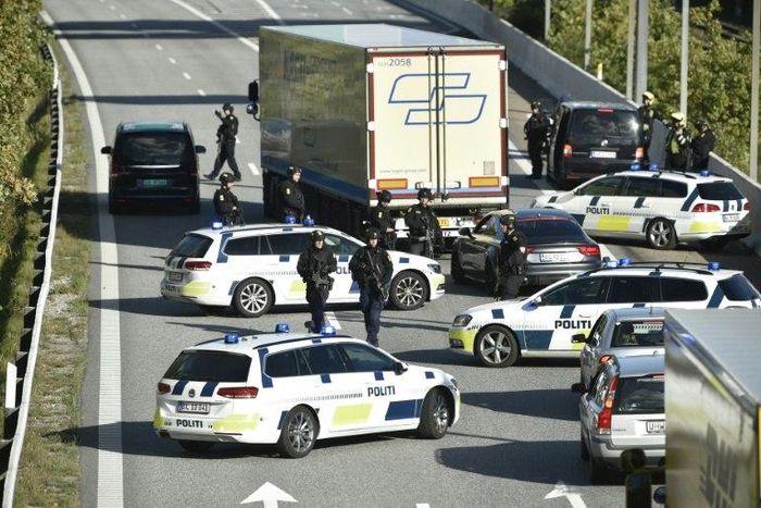 Police block a road to the Oresund Bridge which connects Denmark and Sweden on Friday as part of a massive manhunt