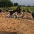 Chief of Army Staff, Lt.-Gen. Tukur Buratai (L), giving instructions to one of the soldiers in trench in frontline in Borno North