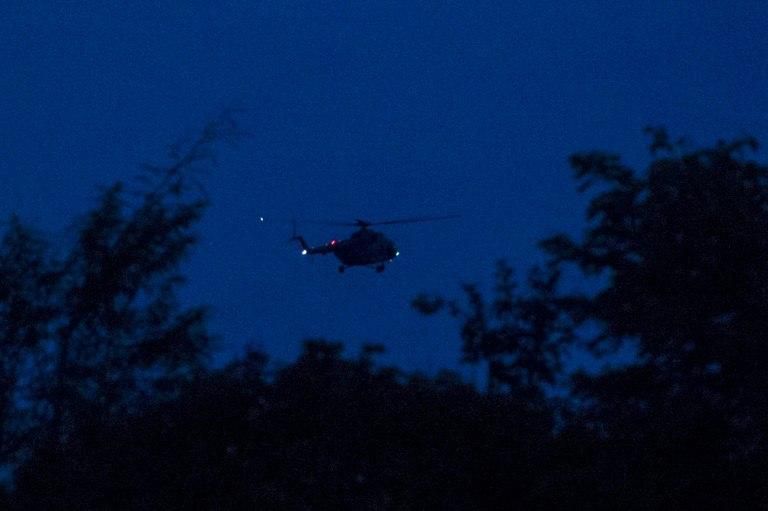 A helicopter used in emergency evacuation for rescued members of the children's football takes off Tham Luang cave area in Khun Nam Nang Non Forest Park in the Mae Sai district of Chiang Rai province on July 10, 2018.All 12 boys and their coach who bec...