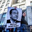 Several dozen people staged a protest outside the State Duma on Wednesday, including one with a picture of Russian Prime Minister Dmitry Medvedev with an inscription reading "An enemy of the people"