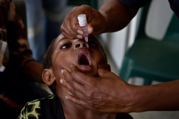 Six-year-old Warapnong Ponde is given a polio vaccination in a mobile clinic in rural Papua New Guinea, as the impoverished country fights a new outbreak of a disease which had previously been eradicated