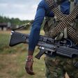 A National Liberation Army (ELN) guerrilla carries a machine gun in a camp on the banks of the San Juan River in the Choco department, in northwestern Colombia