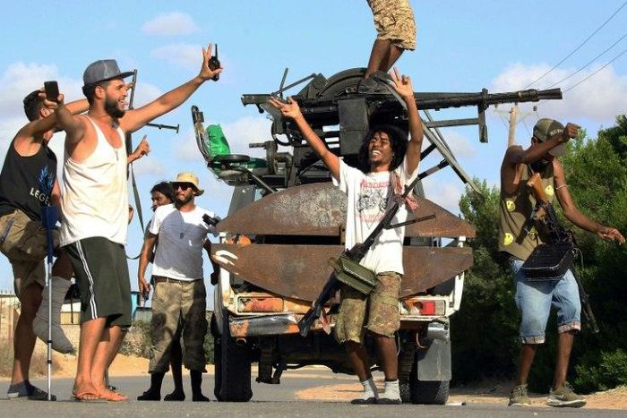 Libyan militiamen loyal to the Government of National Accord (GNA), Libya's internationally recognised government, celebrate advances in the south of the capital Tripoli on September 25, 2018