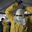 A medical worker puts on protective gear as she prepares to enter an ebola treatment centre run by The Alliance for International Medical Action (ALIMA) in Beni, in the Democratic Republic of Congo
