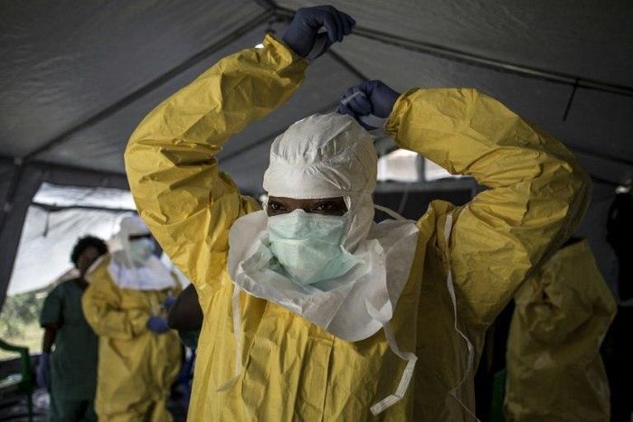 A medical worker puts on protective gear as she prepares to enter an ebola treatment centre run by The Alliance for International Medical Action (ALIMA) in Beni, in the Democratic Republic of Congo