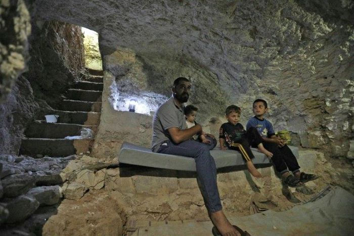 A Syrian family hides in a custom-built cave in Idlib province as negotiations continue to avoid a massive government offensive on the area