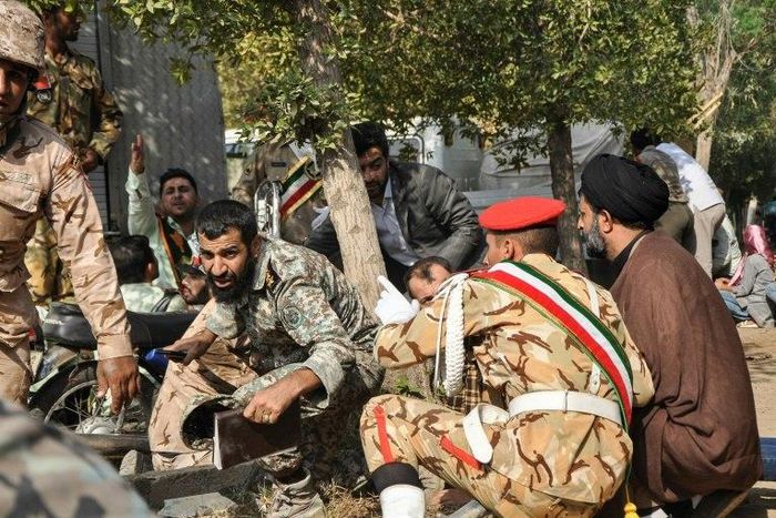 Iranian soldiers and a Shiite Muslim cleric take cover during a gun attack on a military parade in the southwestern city of Ahvaz that has been claimed by the Sunni extremists of the Islamic State group