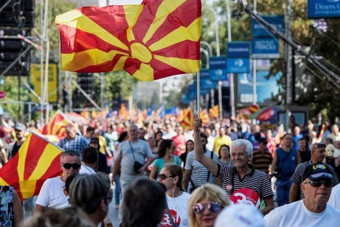 People wave Macedonian flags at a "yes" campaign rally in Skopje ahead of the referendum on whether to change the country's name to "Republic of Northern Macedonia"