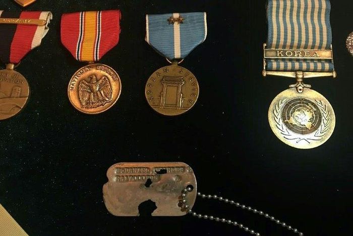 The identity tag and medals belonging to Army Master Sergeant Charles McDaniel, who went missing during the Korean War