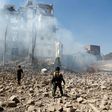 Huthi rebel fighters inspect the damage after a reported air strike by the Saudi-led coalition in Sanaa in December 2017