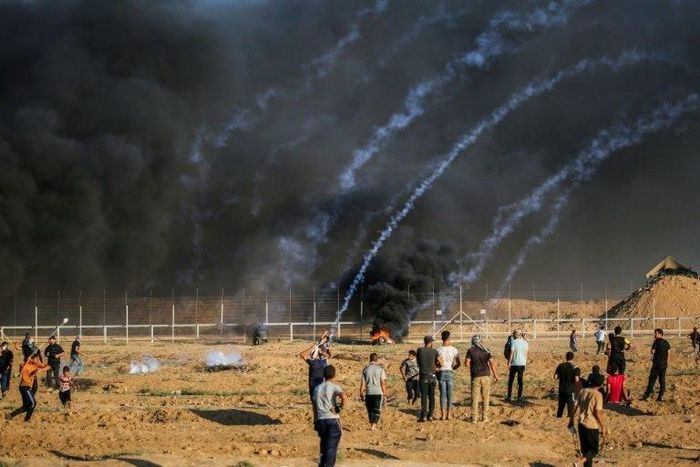 Palestinians protest as Israeli forces fire tear gas near the Israeli fence east of Gaza City on September 21, 2018