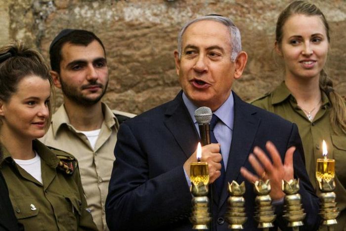 Israeli Prime Minister Benjamin Netanyahu, seen here during a menorah-lighting ceremony with Israeli soldiers for Hanukkah, has hailed majority backing at the UN for condemning militant group Hamas even though a US draft resolution failed to pass