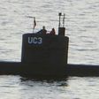 A person believed to be Swedish journalist Kim Wall stands next to a man in the conning tower of the submarine "UC3 Nautilus" made by Peter Madsen who was convicted of her murder.