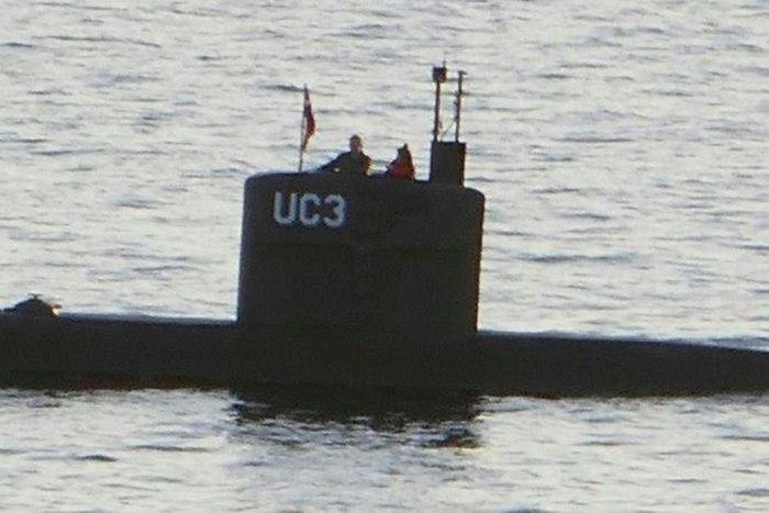 A person believed to be Swedish journalist Kim Wall stands next to a man in the conning tower of the submarine "UC3 Nautilus" made by Peter Madsen who was convicted of her murder.