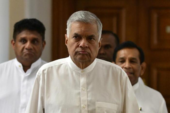 Sri Lanka's ousted premier Ranil Wickremesinghe (C) has refused to vacate the prime minister's official residence since his dismissal in October