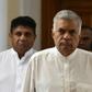 Sri Lanka's ousted premier Ranil Wickremesinghe (C) has refused to vacate the prime minister's official residence since his dismissal in October