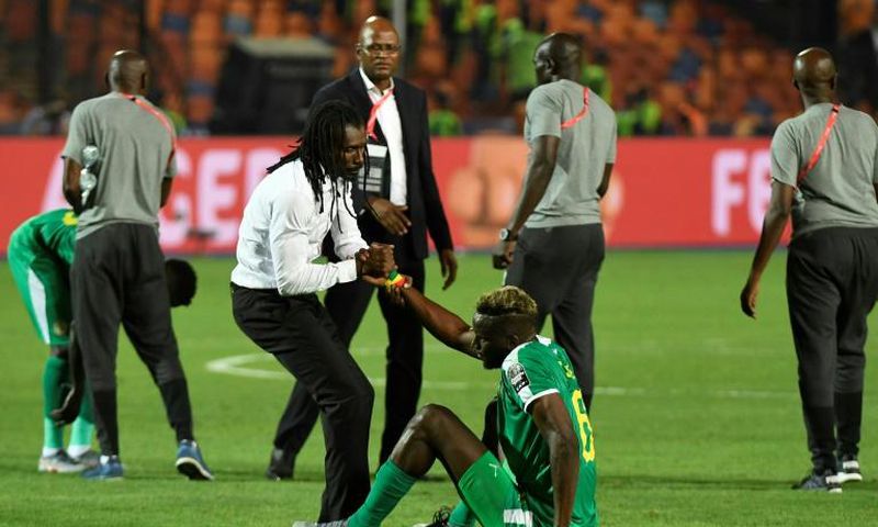 Senegal coach Aliou Cisse consoles defender Salif Sane after defeat in the final