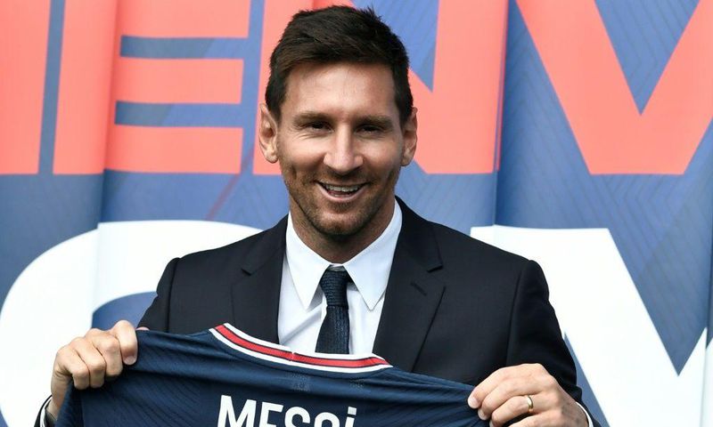 Welcome to Paris: Lionel Messi poses as he holds-up his number 30 shirt