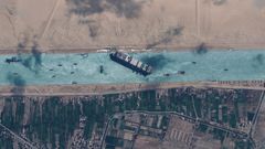 Tugboats work to help free the Even Given ship from the Suez Canal just before noon local time on Monday, March 29, 2021.