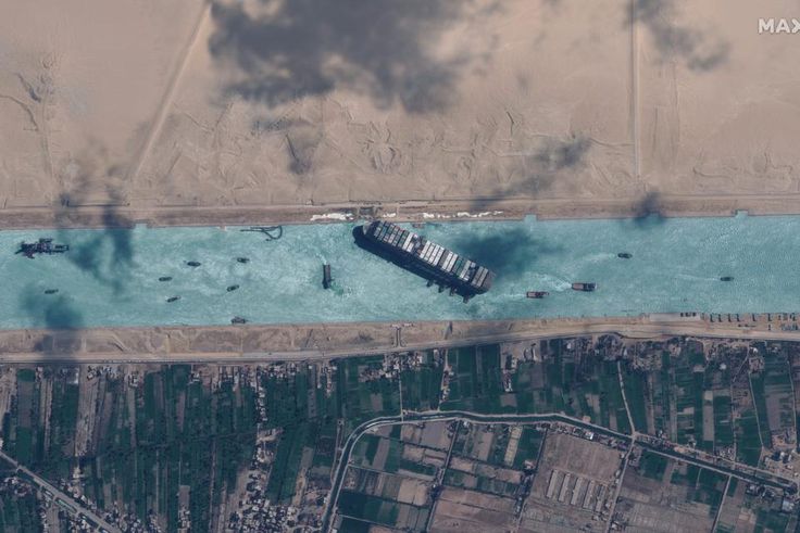 Tugboats work to help free the Even Given ship from the Suez Canal just before noon local time on Monday, March 29, 2021.
