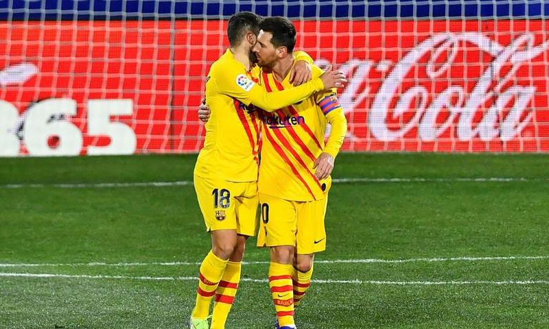 Lionel Messi and Jordi Alba celebrate Barca's opening goal against Huesca