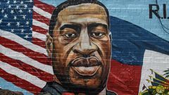 A mural painted by artist Kenny Altidor depicting George Floyd is unveiled on a sidewall of CTown Supermarket on July 13, 2020 in the Brooklyn borough New York City.