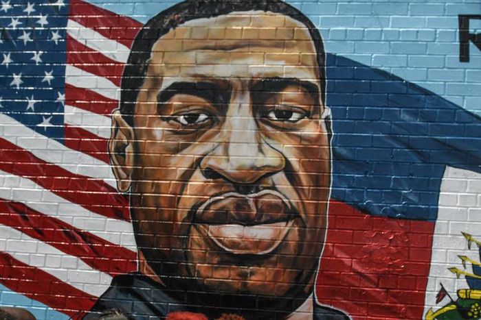 A mural painted by artist Kenny Altidor depicting George Floyd is unveiled on a sidewall of CTown Supermarket on July 13, 2020 in the Brooklyn borough New York City.