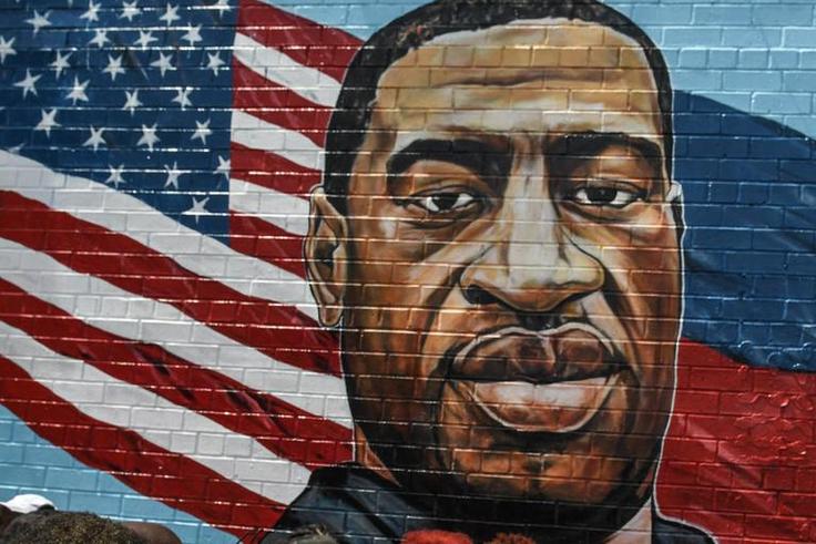 A mural painted by artist Kenny Altidor depicting George Floyd is unveiled on a sidewall of CTown Supermarket on July 13, 2020 in the Brooklyn borough New York City.