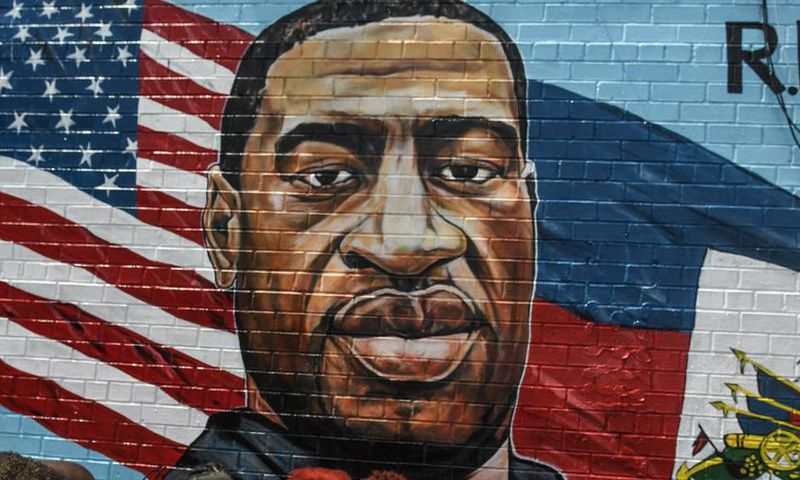 A mural painted by artist Kenny Altidor depicting George Floyd is unveiled on a sidewall of CTown Supermarket on July 13, 2020 in the Brooklyn borough New York City.