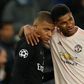 Kylian-Mbappé avec Marcus Rashford pendant un match de LdC entre le PSG et Man United