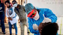 Doctors Without Borders nurse Bhelekazi Mdlalose performs a COVID-19 test on a health worker at the Vlakfontein Clinic in Johannesburg, South Africa, on May 13, 2020.