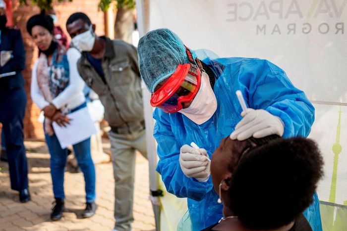 Doctors Without Borders nurse Bhelekazi Mdlalose performs a COVID-19 test on a health worker at the Vlakfontein Clinic in Johannesburg, South Africa, on May 13, 2020.