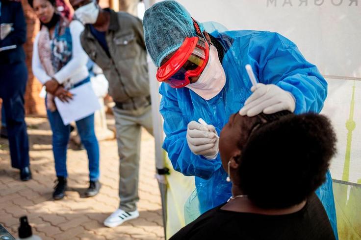 Doctors Without Borders nurse Bhelekazi Mdlalose performs a COVID-19 test on a health worker at the Vlakfontein Clinic in Johannesburg, South Africa, on May 13, 2020.