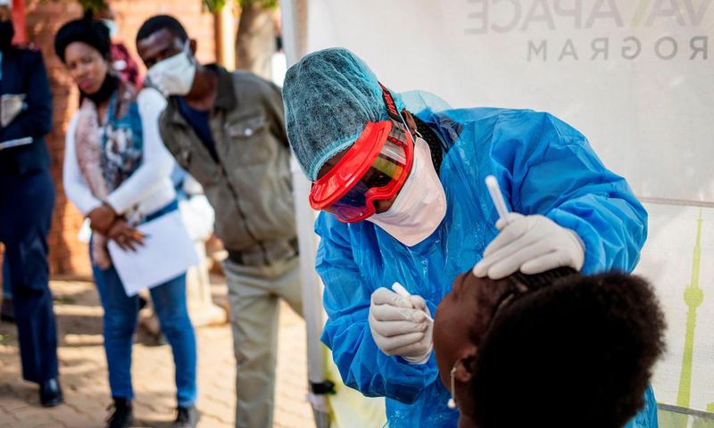 Doctors Without Borders nurse Bhelekazi Mdlalose performs a COVID-19 test on a health worker at the Vlakfontein Clinic in Johannesburg, South Africa, on May 13, 2020.
