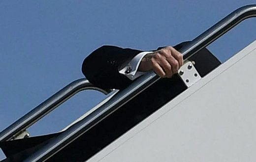 President Joe Biden trips while boarding Air Force One at Joint Base Andrews in Maryland on March 19, 2021.
