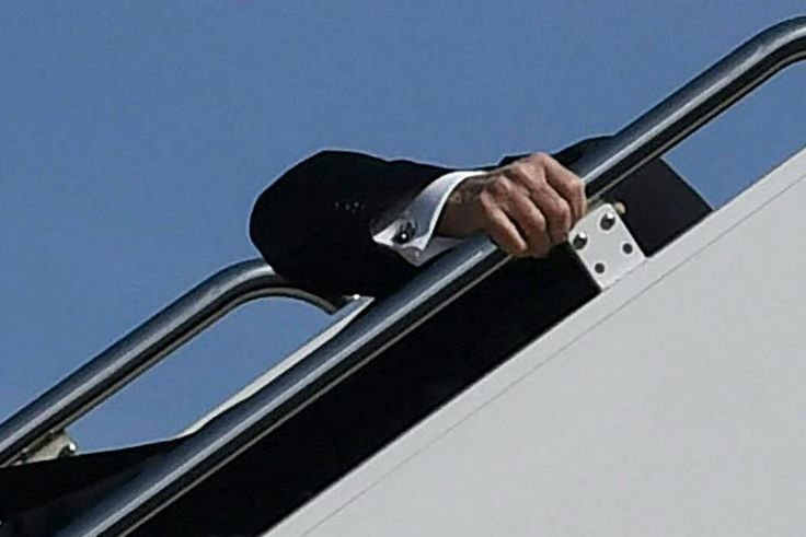 President Joe Biden trips while boarding Air Force One at Joint Base Andrews in Maryland on March 19, 2021.