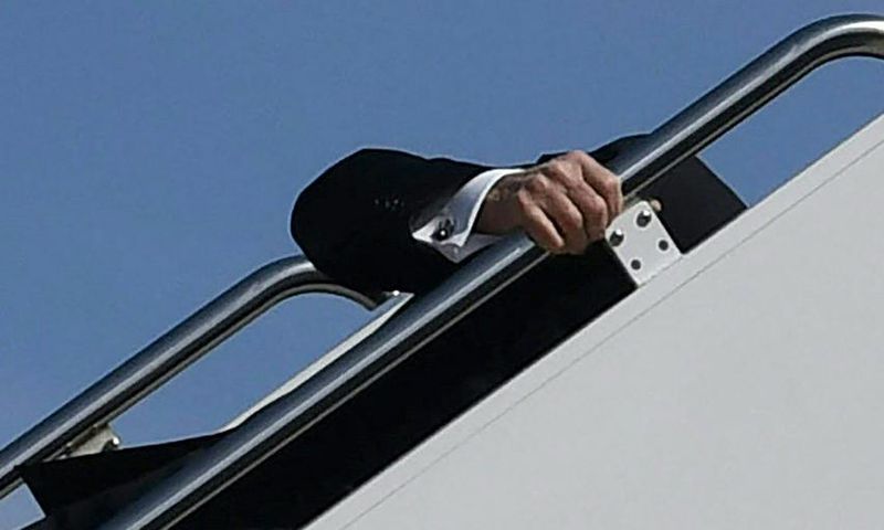 President Joe Biden trips while boarding Air Force One at Joint Base Andrews in Maryland on March 19, 2021.