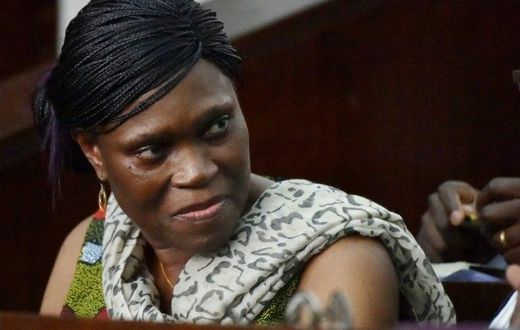 Former Ivorian first lady Simone Gbagbo looks on at Abidjan's courthouse on October 10, 2016 before the re-opening of her trial