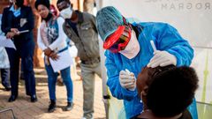 Doctors Without Borders nurse Bhelekazi Mdlalose performs a COVID-19 test on a health worker at the Vlakfontein Clinic in Johannesburg, South Africa on May 13, 2020.